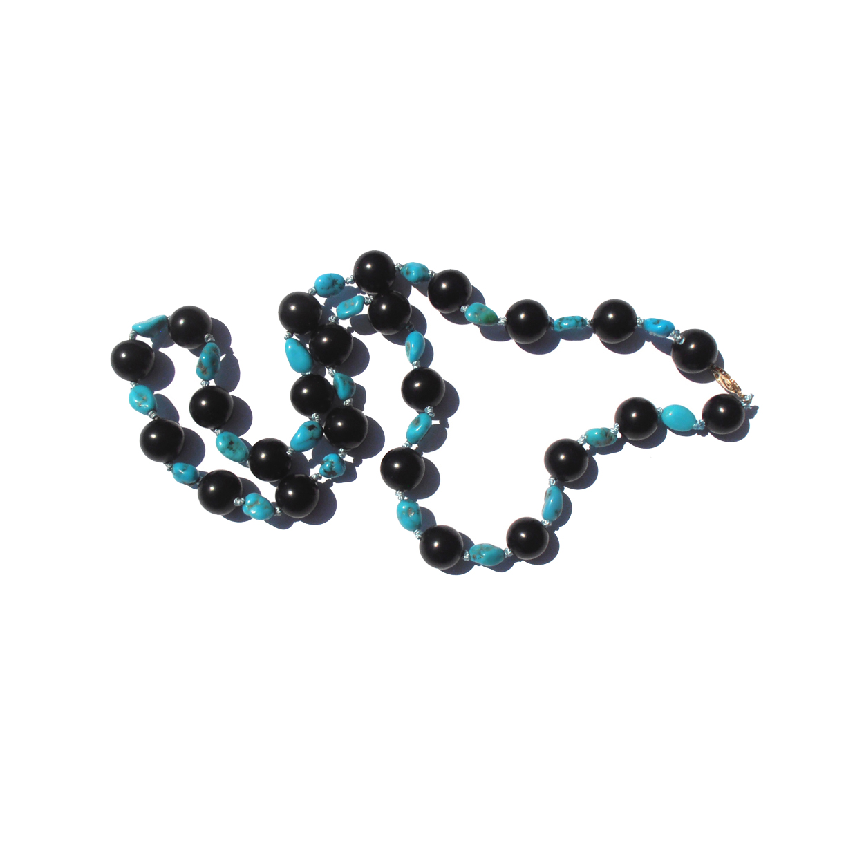 One-of-a-kind American Turquoise (from the Blue Gem Mine) and natural British Jet necklace. Handknotted on silk with a 14k gold clasp. $695.-USD